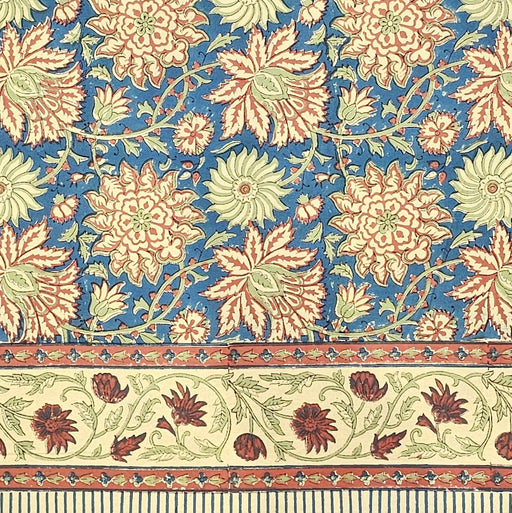 Dusky indigo slate hand-block printed cotton tablecloth with Terracotta-rust, warm peach-cream, and soft sage-celadon botanicals.