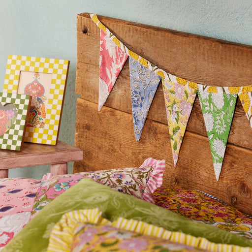 Patchwork Block Print Bunting accross a bed headboard