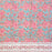 Floral-patterned tablecloth with pink flowers and blue leaves on a pink background