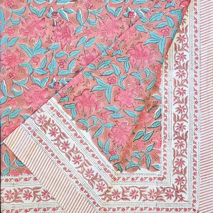 Floral-patterned pink lily tablecloth folded