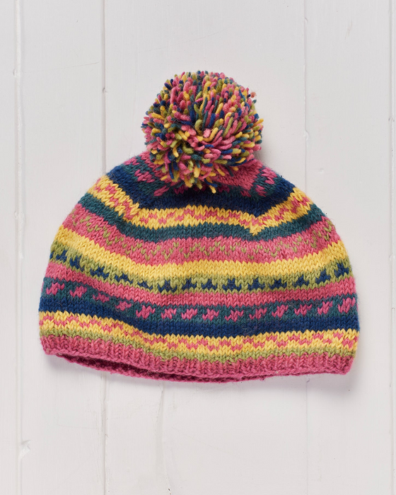 A hand knitted and fleece lined Pokhara Pompom Beanie Hat.