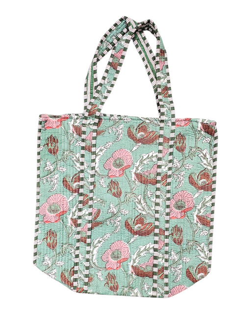 Pink Floral patterned tote bag on a green background