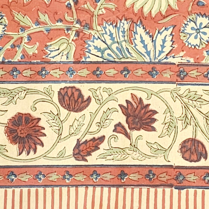 Terracotta rust and slate blue hand-block printed botanical themed cotton tablecloth with ticking-stripe edge - detailing the border.