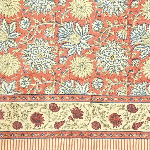 Terracotta rust and slate blue hand-block printed botanical themed cotton tablecloth with ticking-stripe edge.