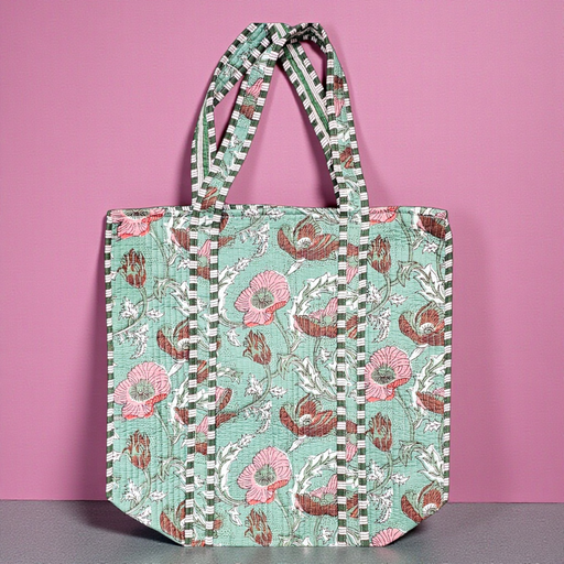 Sage Meadow Quilted Cotton Tote Bag on a grey shelf and set against a pink backdrop