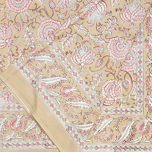 Decorative block printed tablecloth with pink and white floral pattern on a beige background