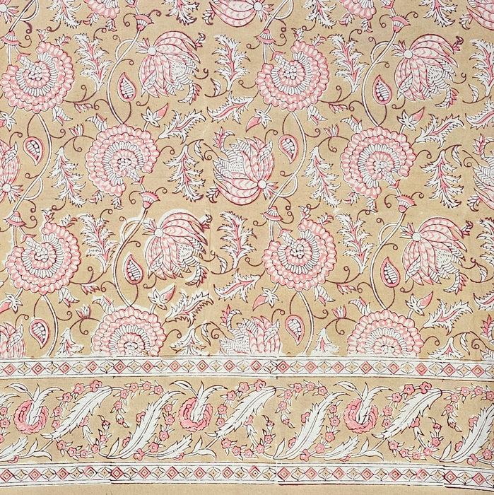 Block printed tablecloth with a pink and white floral design on a beige background