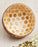 Coconut bowl with honeycomb pattern on a light background