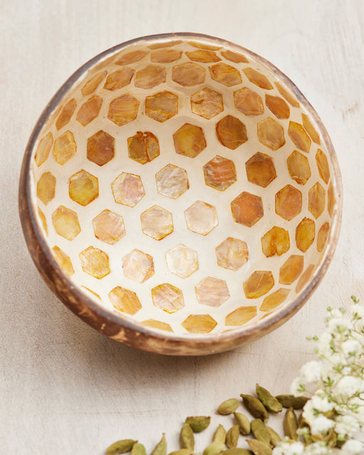 Coconut bowl with honeycomb pattern on a light background