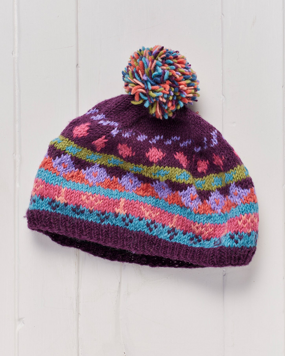 A hand knitted and fleece lined Shivalaya Pompom Beanie Hat.