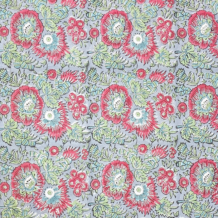 The main panel design of a Handcrafted 100% cotton tablecloth in Slate Garden print, showing crimson red flowers, sage green leaves on a blue-grey background.
