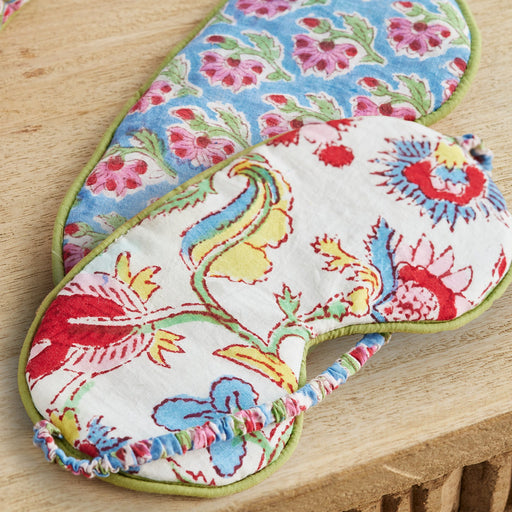 Colorful floral patterned eye mask on a wooden surface