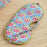 Blue Floral-patterned eye mask on a wooden surface