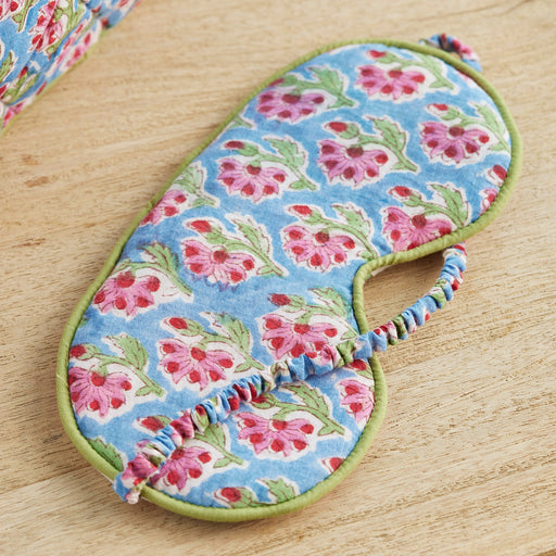 Blue Floral-patterned eye mask on a wooden surface