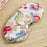 Colorful floral-patterned eye mask on a wooden surface