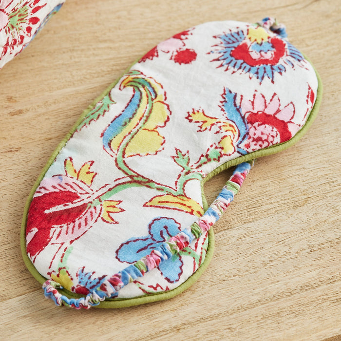 Colorful floral-patterned eye mask on a wooden surface