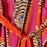 Colorful fabric with tiger stripe pattern and bright orange accents