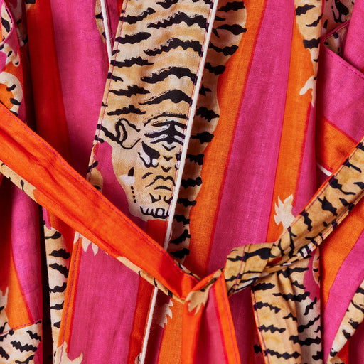 Colorful fabric with tiger stripe pattern and bright orange accents