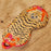 Tiger-patterned eye mask on a wooden surface