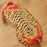 Sleep mask with tiger design on a wooden surface