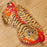 Sleep mask with tiger pattern on a wooden surface