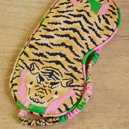 Eyemask with tiger pattern on a wooden surface