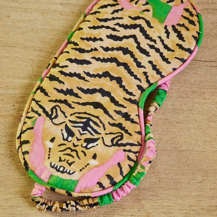 Eyemask with tiger pattern on a wooden surface