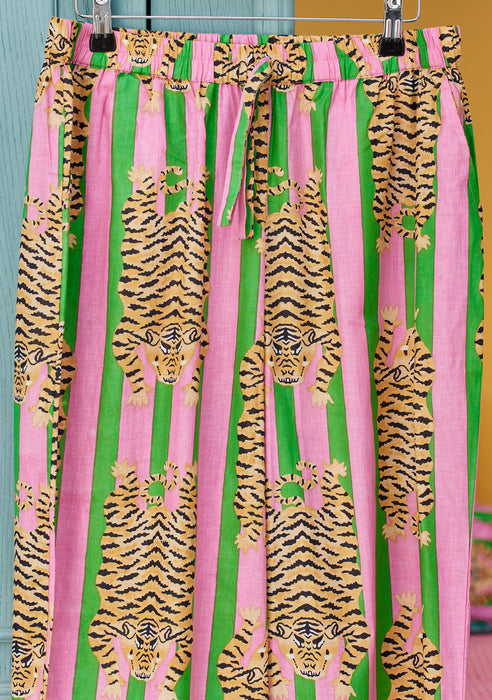 Tiger print pyjama bottoms pattern on a hanger against a neutral background