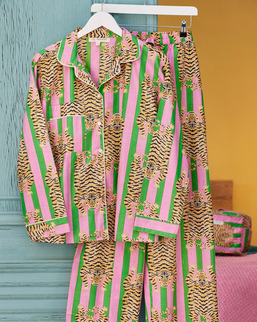 Tiger Stripe Pyjamas on a hanger against a colourful background