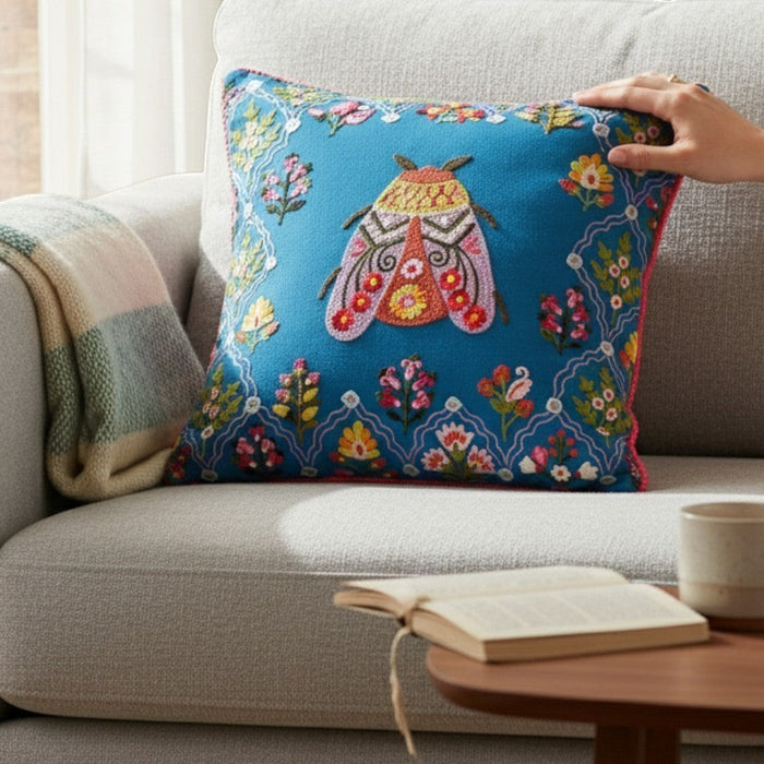 Araucaria midnight blue cotton cushion cover with embroidered bug and floral border. 45x45cm.