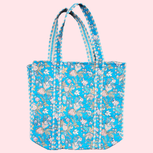 blue floral cotton quilted tote bag on a soft pink background