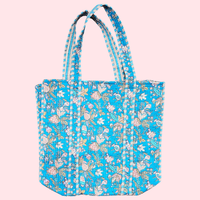 blue floral cotton quilted tote bag on a soft pink background