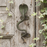Decorative brass cobra handle with a green patina on a white washed wooden door with ivy leaves