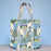 Quilted cotton tote bag featuring a tropical pattern of peacocks and domed temples on a soft light blue background.