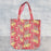 Red leopard tote bag set against a textured grey background