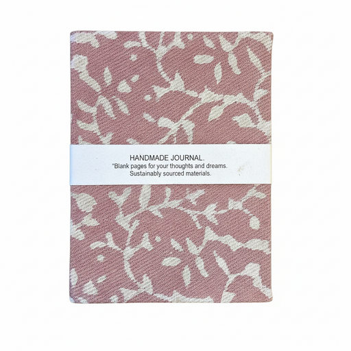 Pink and white patterned book with 'Fair Trade Handmade Paper Book' label on a light green background