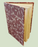 Book with a patterned cover on a light green background