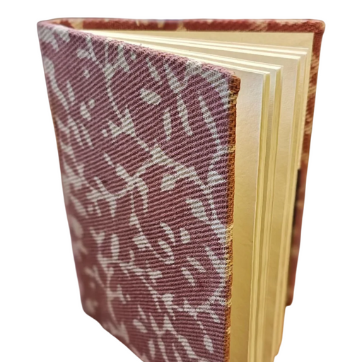 Book with a patterned cover on a light green background