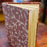 Book with a patterned cover on a wooden surface