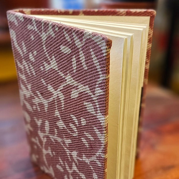 Book with a patterned cover on a wooden surface