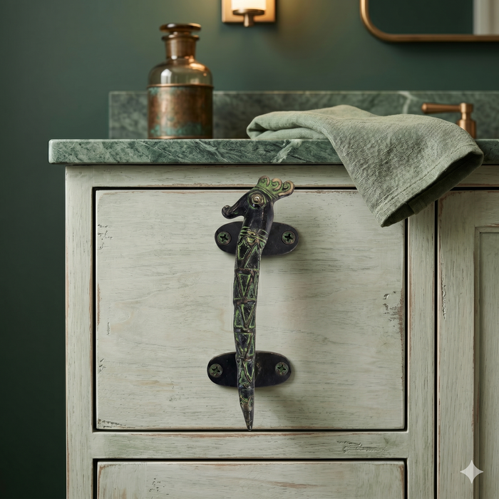 Vintage-style wooden cabinet with a decorative seahorse brass handle against a dark green wall.