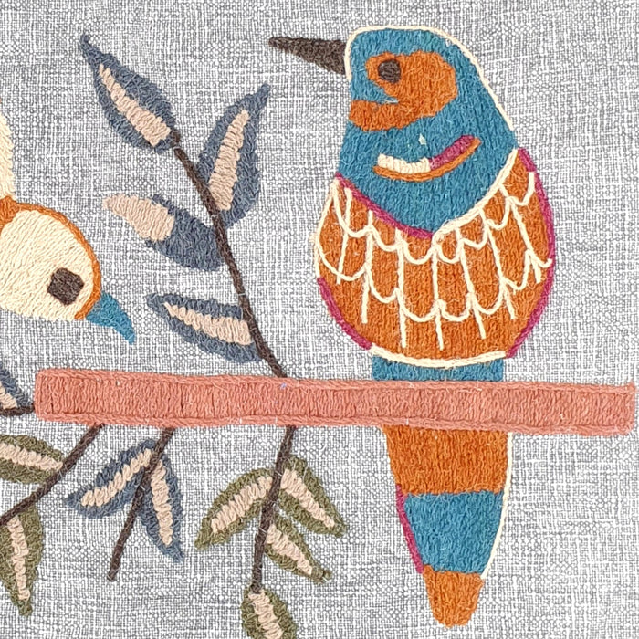 Close up of embroidered bird cushion cover